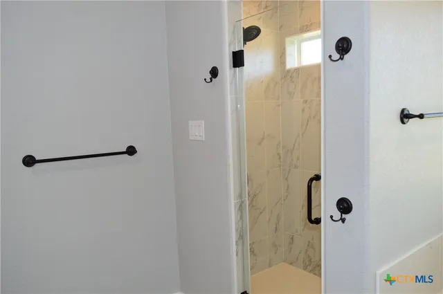 a bathroom with a granite countertop double vanity sink and a mirror