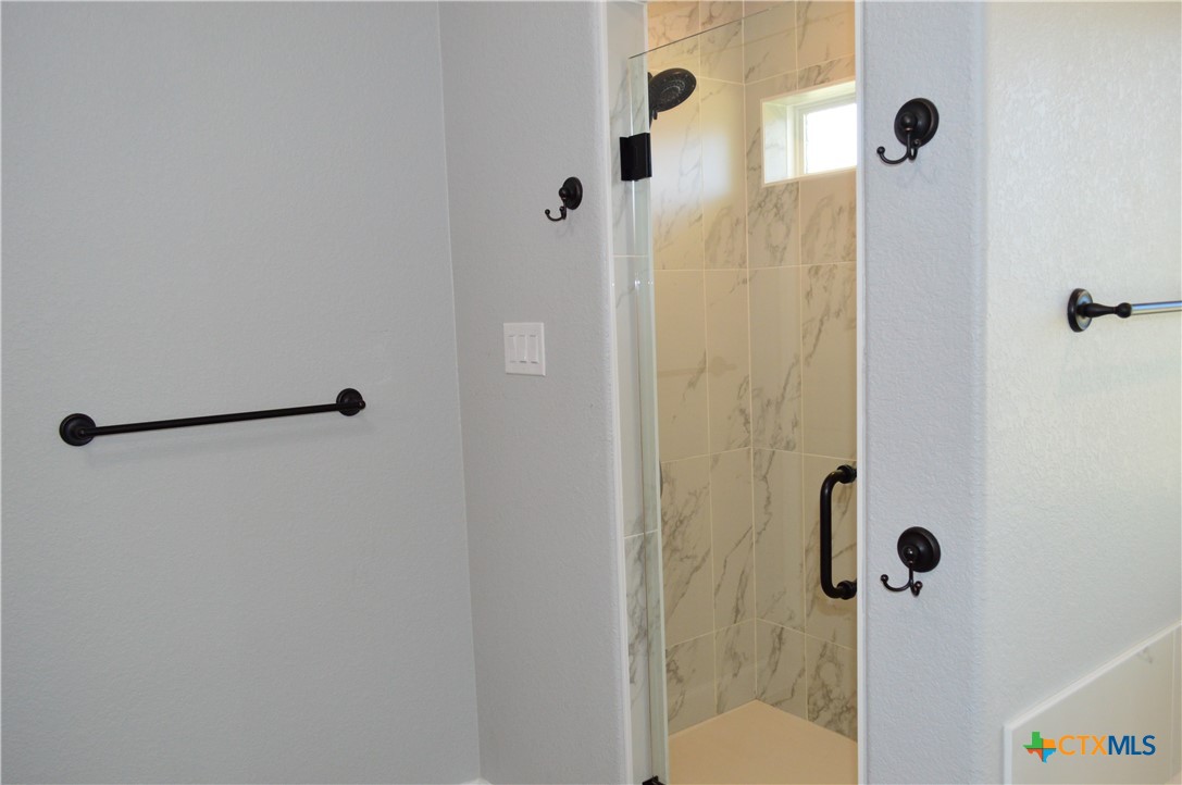 1026 County Road 3152 Kempner, TX 76539 - Photo 23 of 48 The master bath has granite countertops with two individual sink areas, framed mirrors, lots of storage, soaker tub, separate shower, and private water closet.