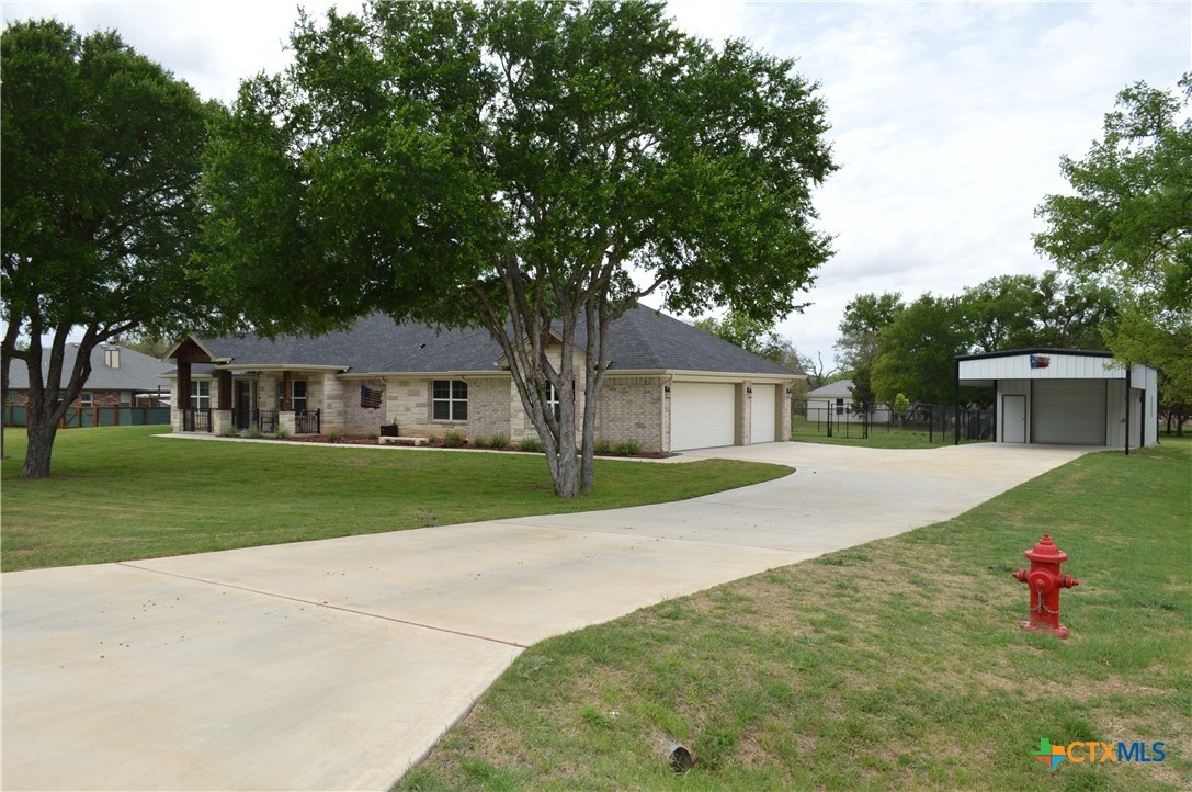 1026 County Road 3152 Kempner, TX 76539 - Photo 3 of 48 a front view of a house with a yard and garage