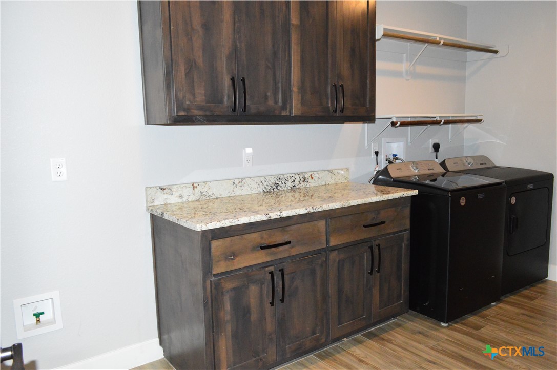 1026 County Road 3152 Kempner, TX 76539 - Photo 31 of 48 Laundry Room with Granite Countertop, Abundant Storage, Space and Water Line for a Second Refrigerator ** The washer and dryer are included.