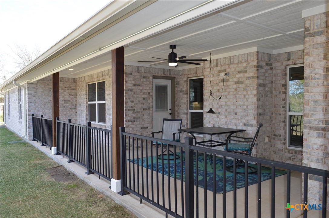 1026 County Road 3152 Kempner, TX 76539 - Photo 34 of 48 34' Covered Patio with Decorative Wrought Iron Fencing and Gate to the Flat Back Yard * Gutters