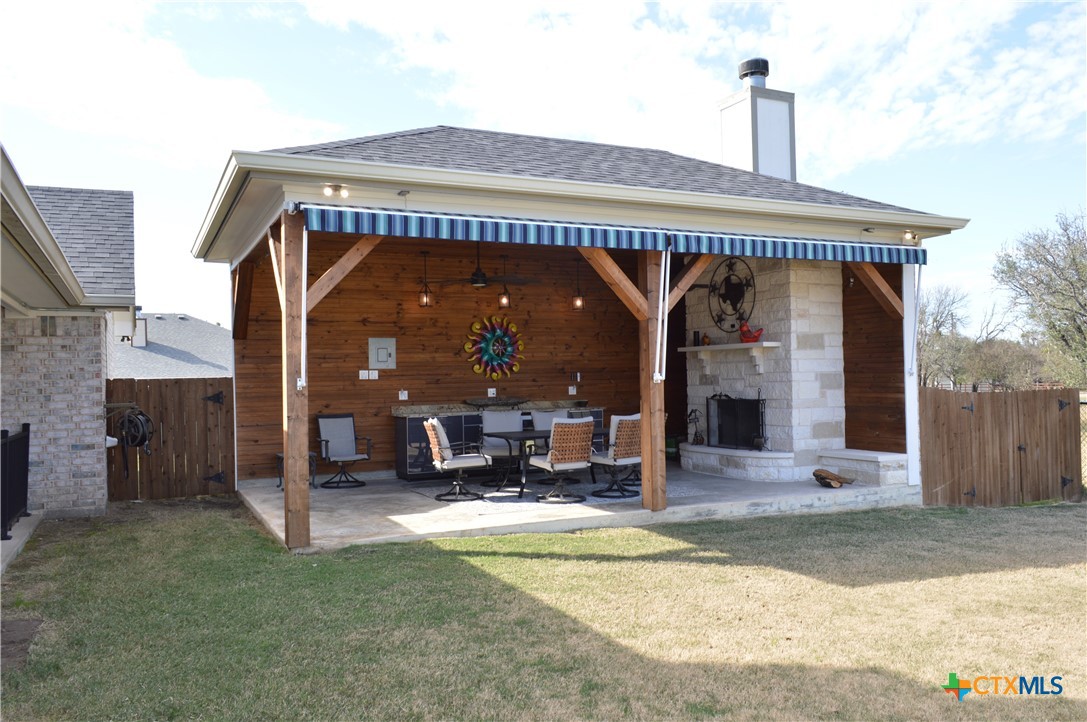 1026 County Road 3152 Kempner, TX 76539 - Photo 38 of 48 Custom One-of-a-Kind Outdoor Entertainment Area with Cabinets with Granite Countertop and Pendant Lighting, Ceiling Fan, Electric Awning (Rolled Up) and Over-Sized Stone Fireplace