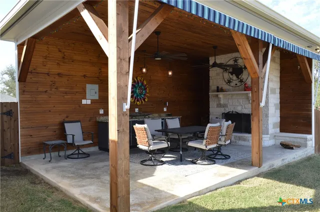 a view of a house with backyard porch and sitting area