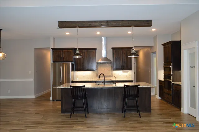 wooden floor fireplace and windows in an empty room