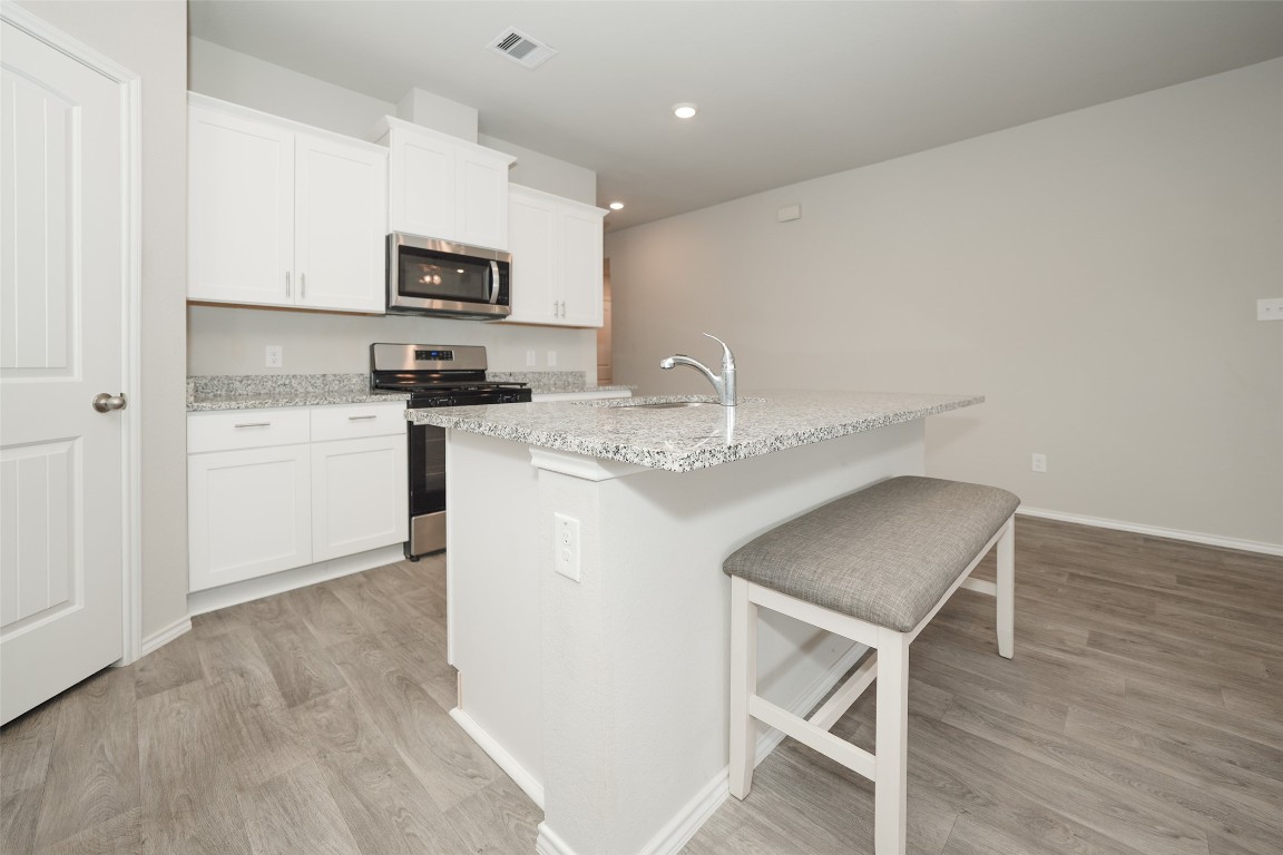 2407 Divot Lane Navasota, TX 77868 - Photo 16 of 37 a kitchen with stainless steel appliances granite countertop a microwave sink and refrigerator