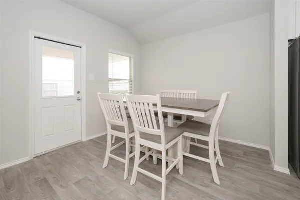 a view of a dining room with furniture and wooden floor
