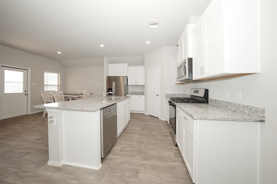 2407 Divot Lane Navasota, TX 77868 - Photo 24 of 37 a kitchen with a sink stove and cabinets