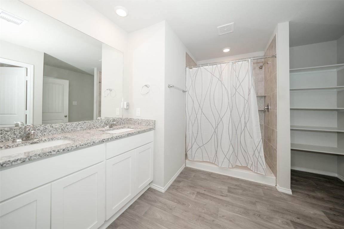 2407 Divot Lane Navasota, TX 77868 - Photo 26 of 37 a bathroom with a granite countertop sink and a mirror