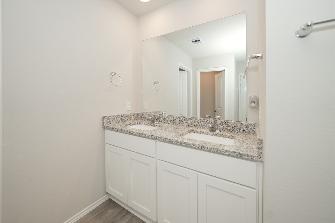 2407 Divot Lane Navasota, TX 77868 - Photo 29 of 37 a bathroom with a granite countertop sink and a mirror