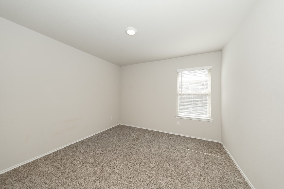 2407 Divot Lane Navasota, TX 77868 - Photo 3 of 37 an empty room with a window