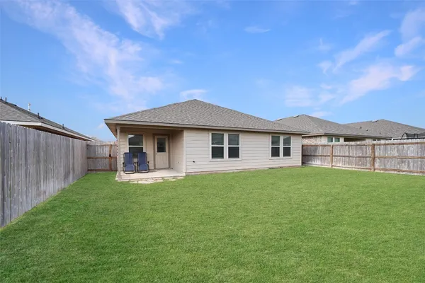 a house view with garden space and wooden fence