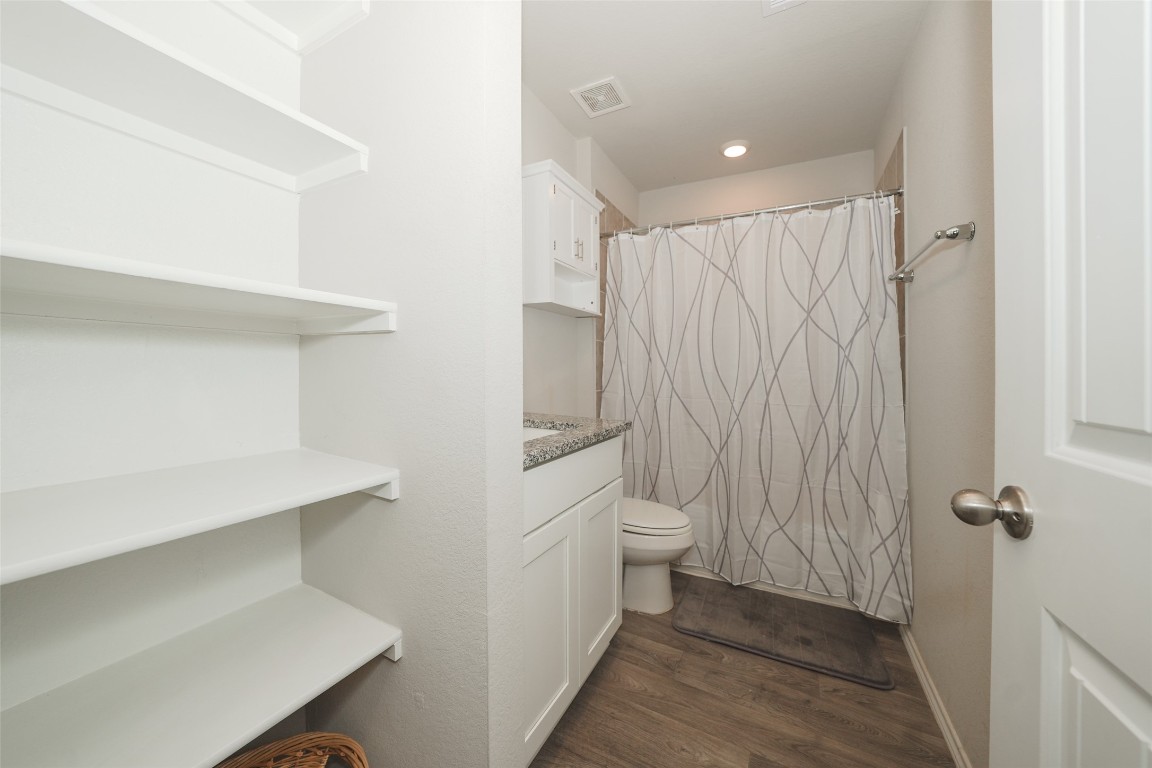 2407 Divot Lane Navasota, TX 77868 - Photo 5 of 37 a bathroom with a sink a toilet and shower