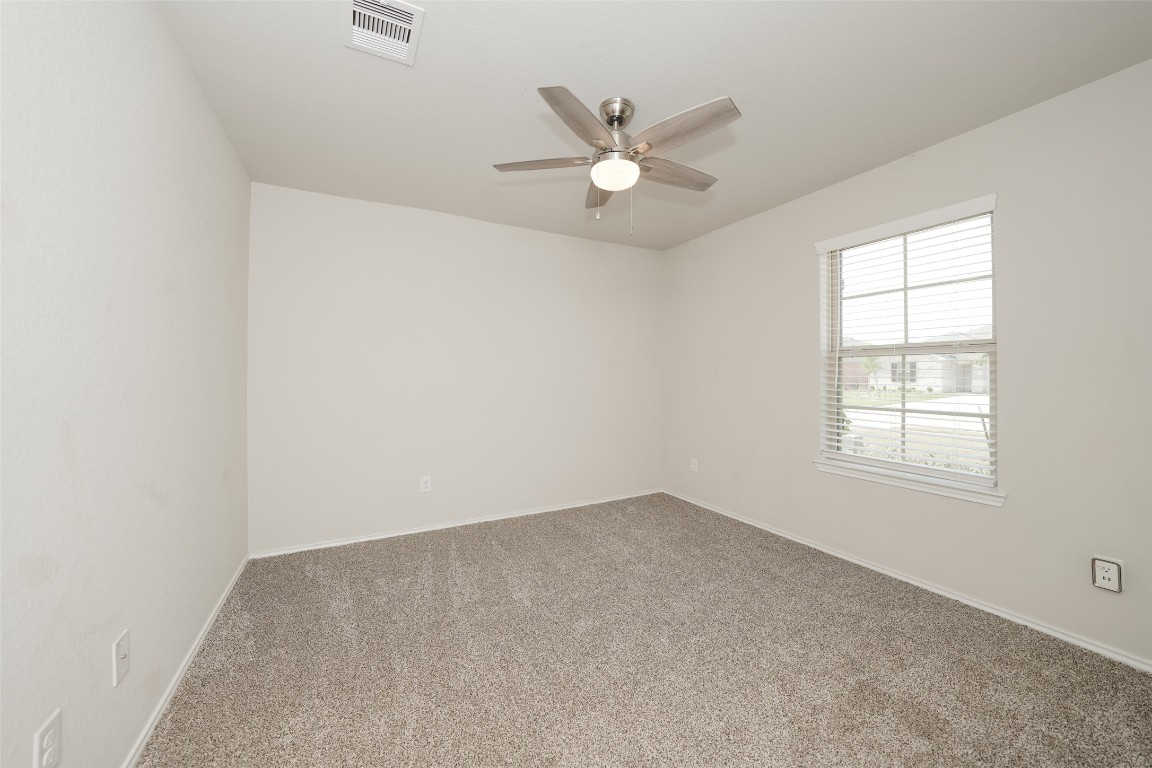 2407 Divot Lane Navasota, TX 77868 - Photo 6 of 37 an empty room with a window and a fan