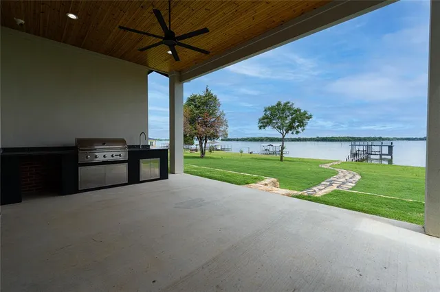 a view of a patio with couches and a table and chairs with garden view