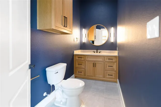 a view of an empty room with kitchen and a window