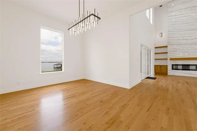 a dining room with furniture potted plants and wooden floor