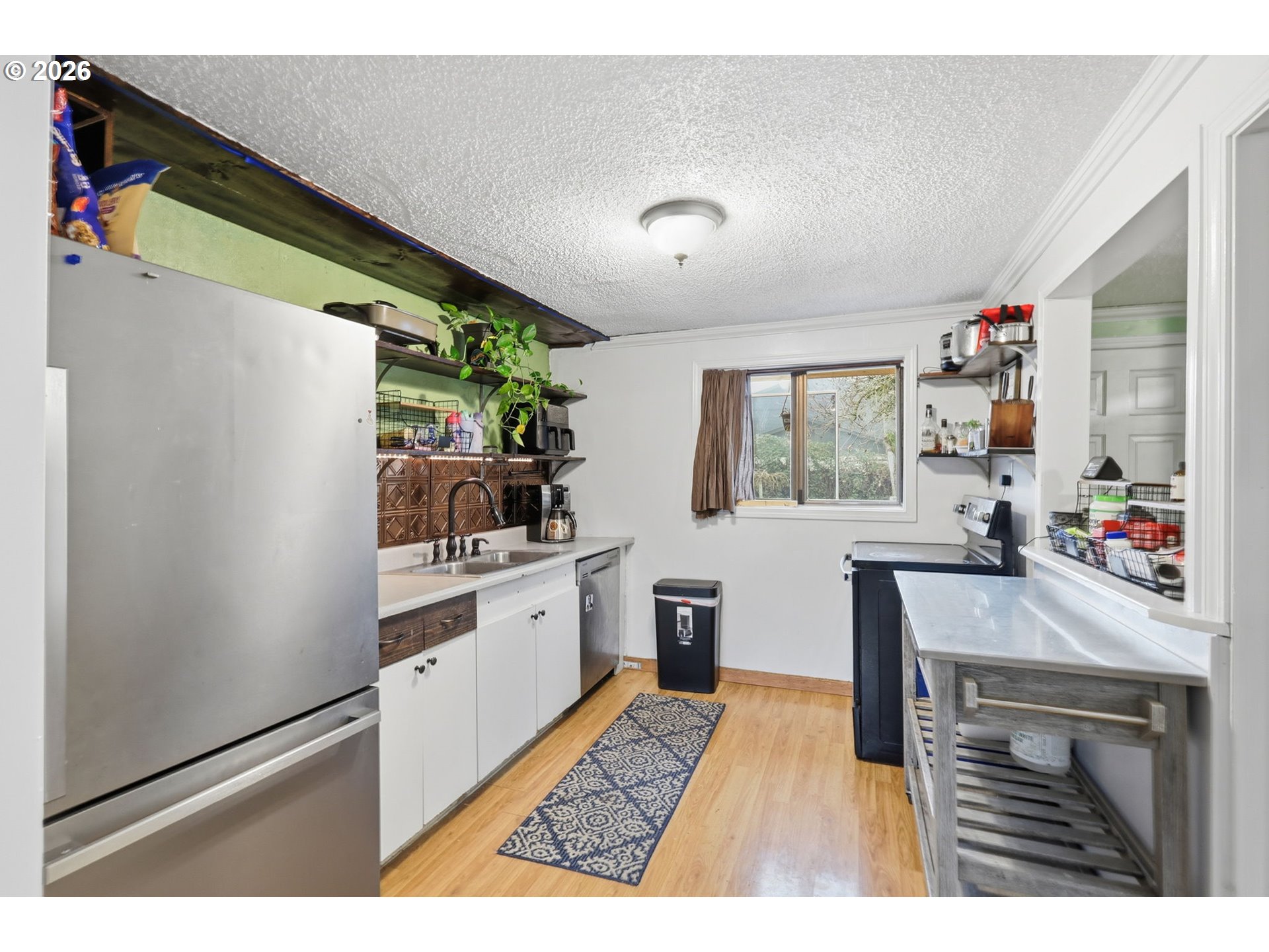 1891 Scott Road Springfield, OR 97477 - Photo 16 of 38 a kitchen with stainless steel appliances granite countertop a refrigerator and a stove with wooden floor