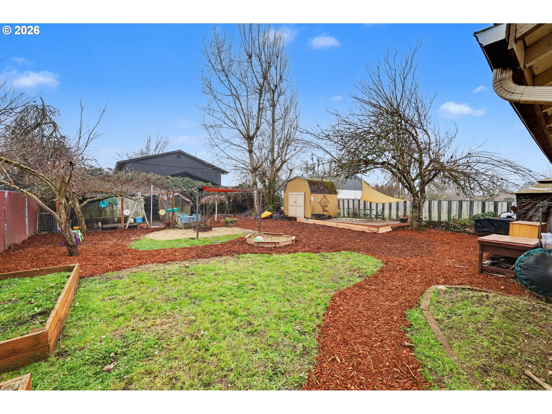 1891 Scott Road Springfield, OR 97477 - Photo 37 of 38 a view of a yard with table and chairs under an umbrella