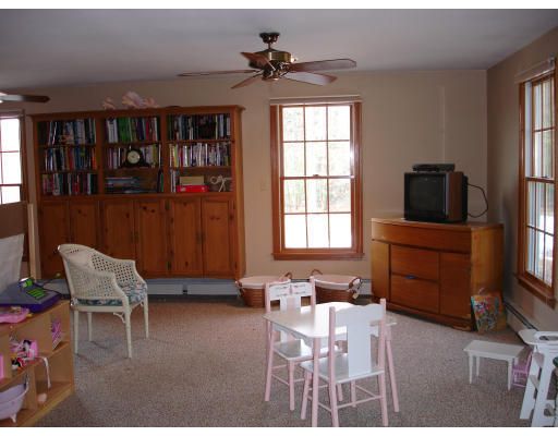 82 Whiley Road Groton, MA 01450 - Photo 18 of 30 a living room with furniture a flat screen tv and a window