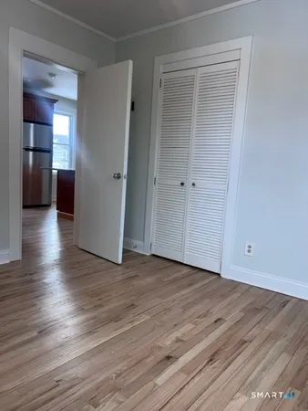 a view of a livingroom with wooden floor and closet