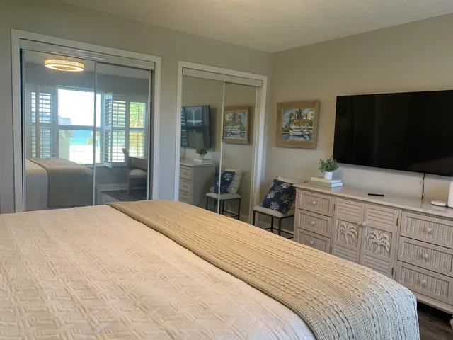 a bedroom with two beds and a chandelier