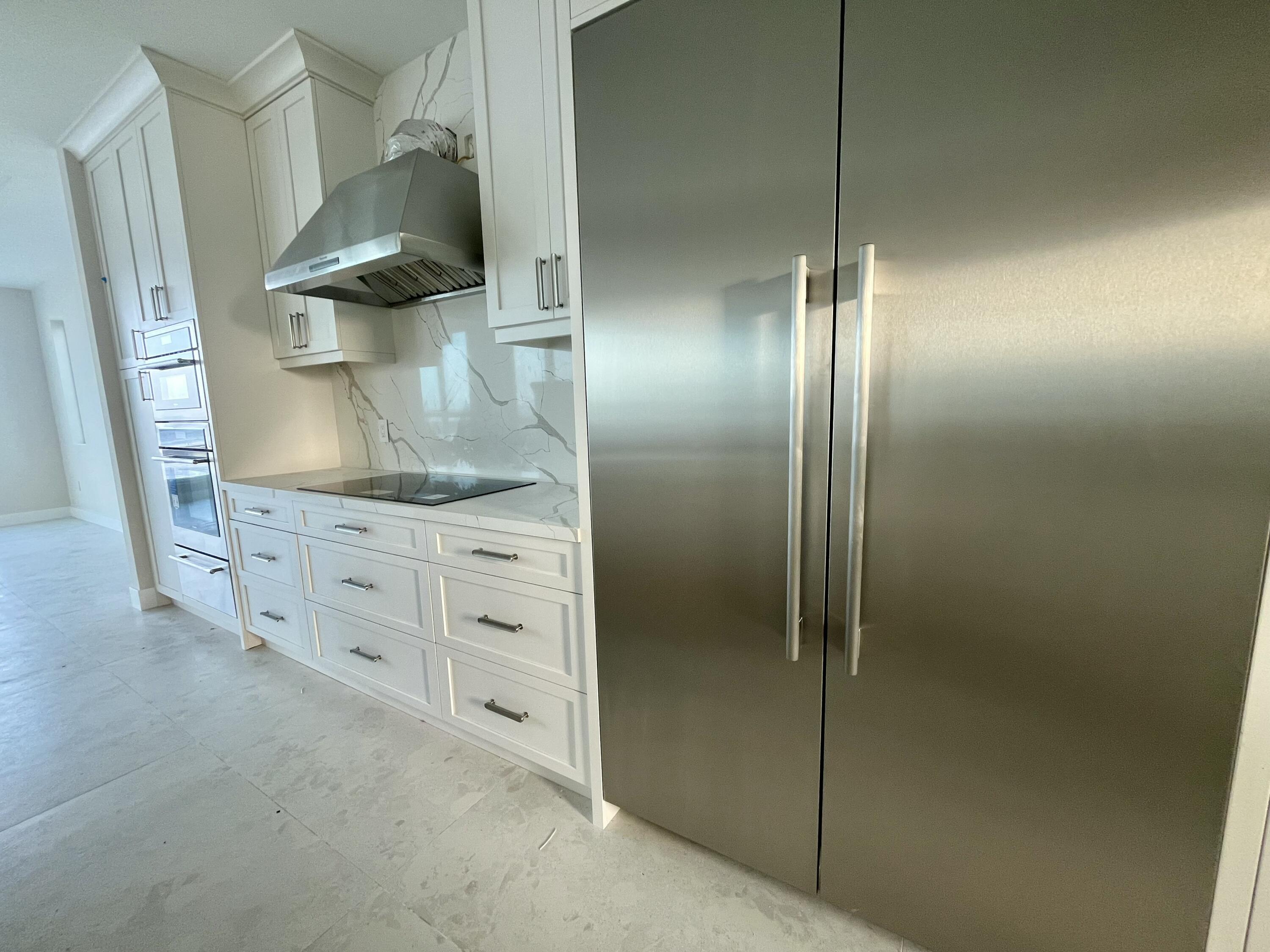 128 Sunrise Drive Marathon, FL 33050 - Photo 16 of 40 a kitchen with stainless steel appliances granite countertop a sink and a refrigerator