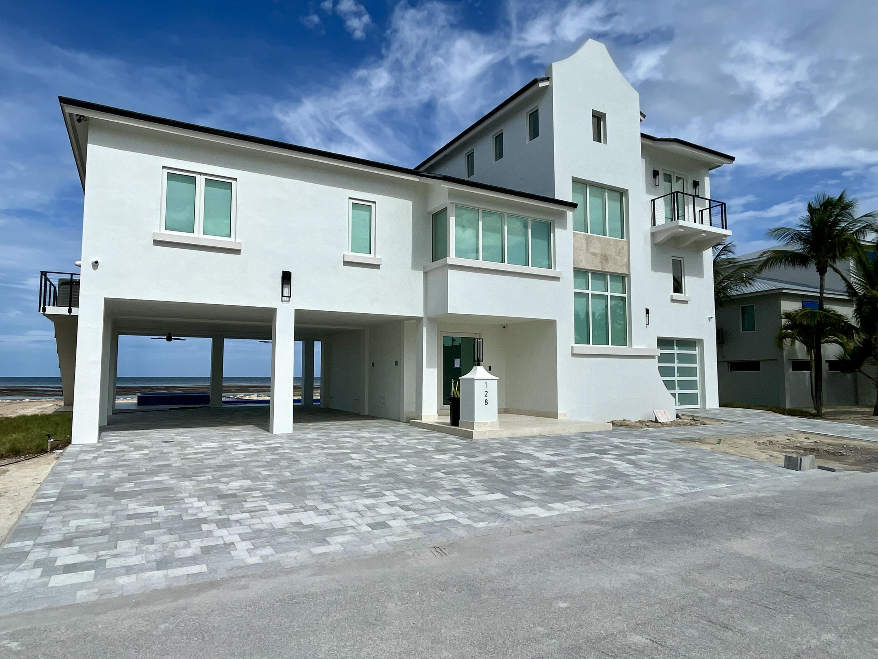 128 Sunrise Drive Marathon, FL 33050 - Photo 2 of 40 a view of a house with a patio and a yard