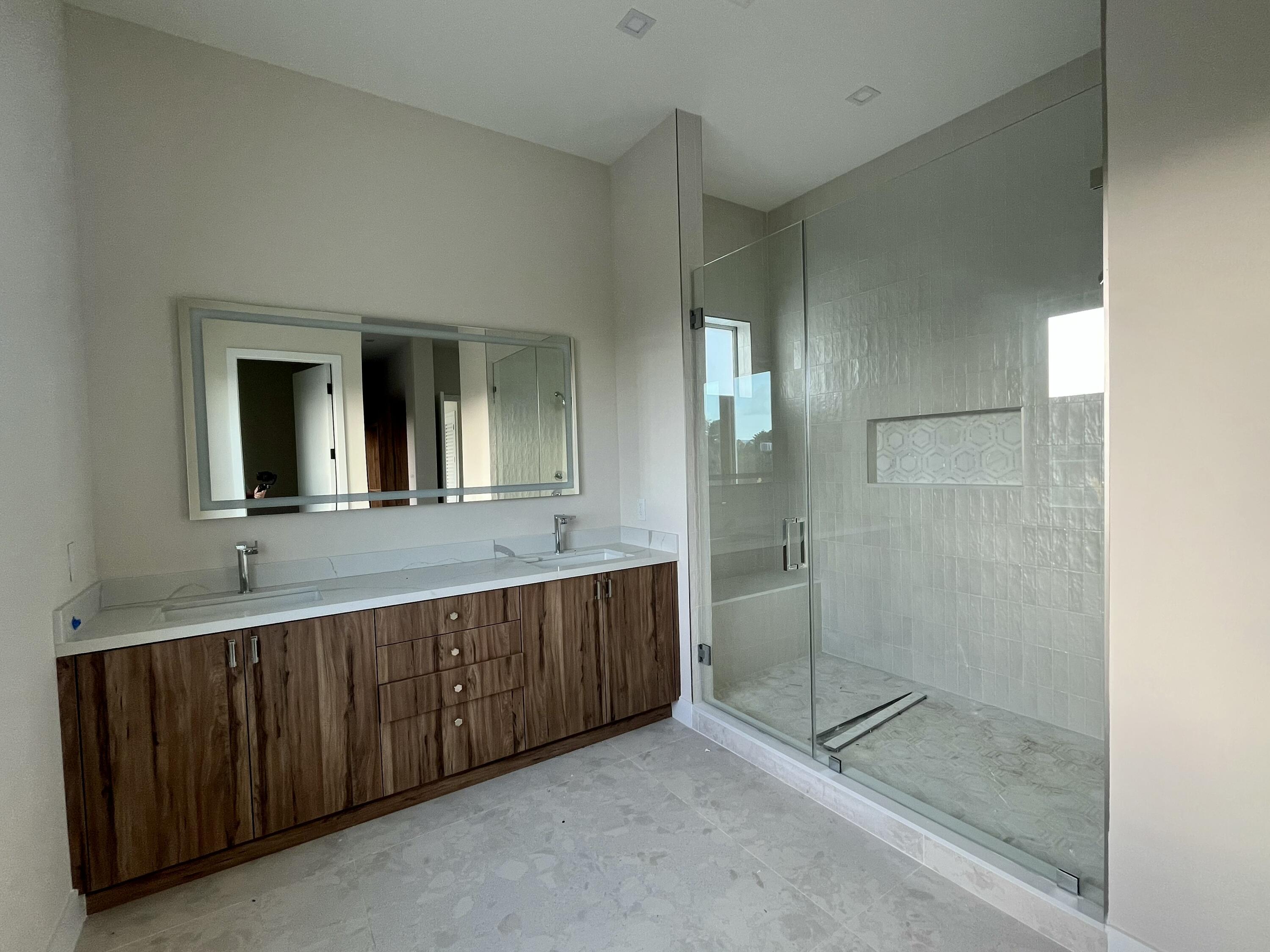 128 Sunrise Drive Marathon, FL 33050 - Photo 25 of 40 a bathroom with a shower sink and mirror