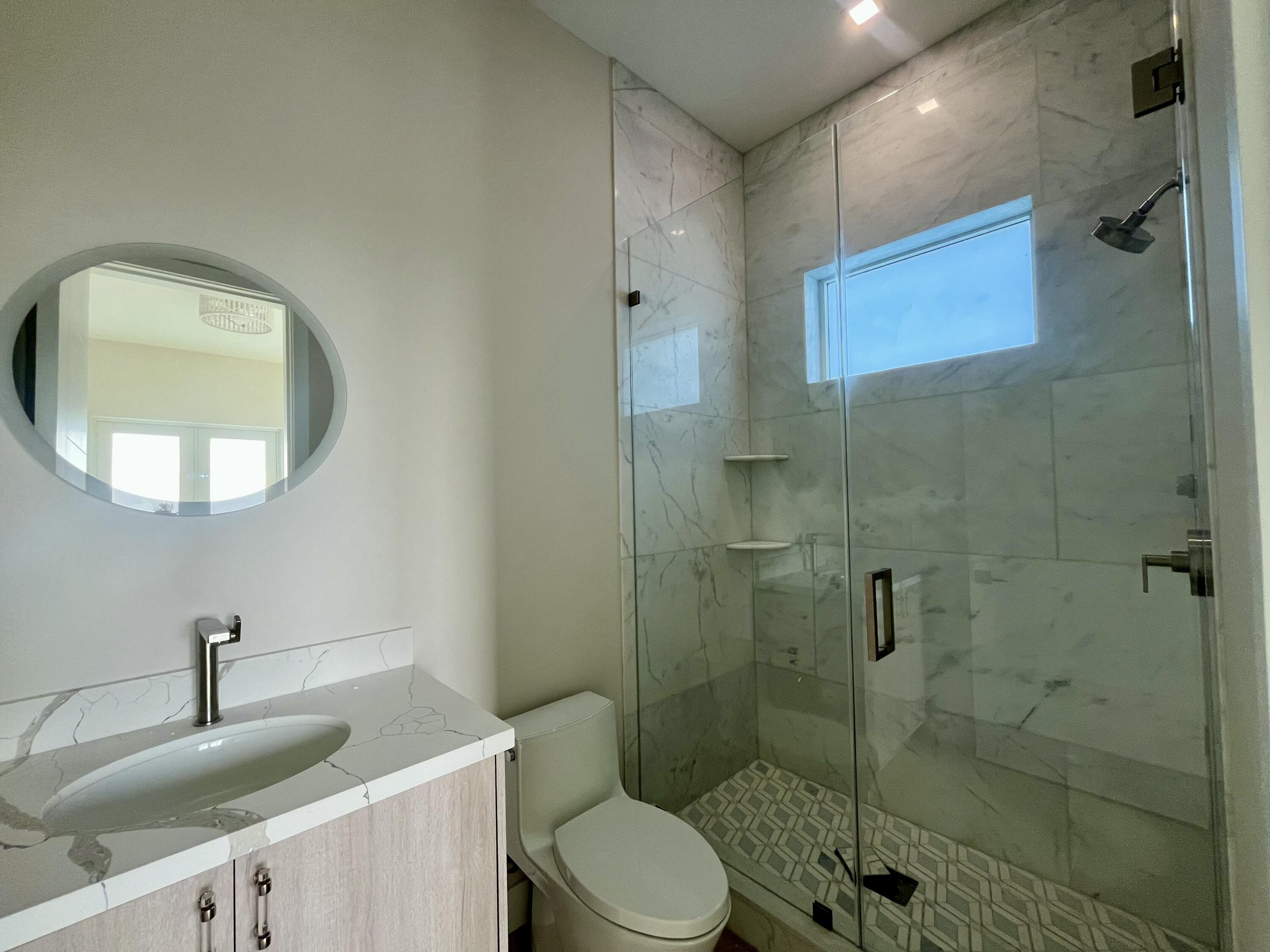 128 Sunrise Drive Marathon, FL 33050 - Photo 27 of 40 a bathroom with a sink a toilet and shower