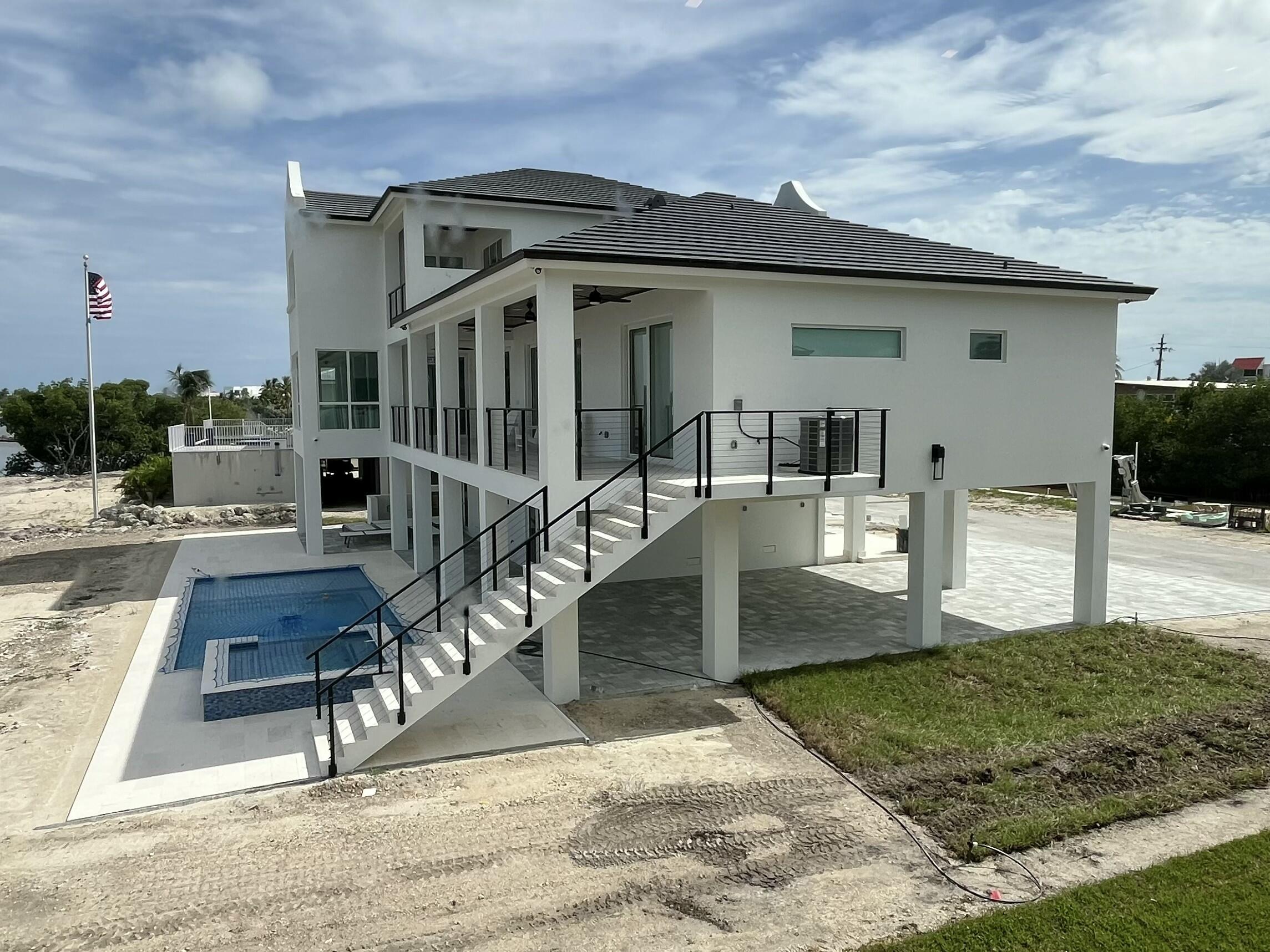 128 Sunrise Drive Marathon, FL 33050 - Photo 29 of 40 a view of a house with backyard porch and sitting area