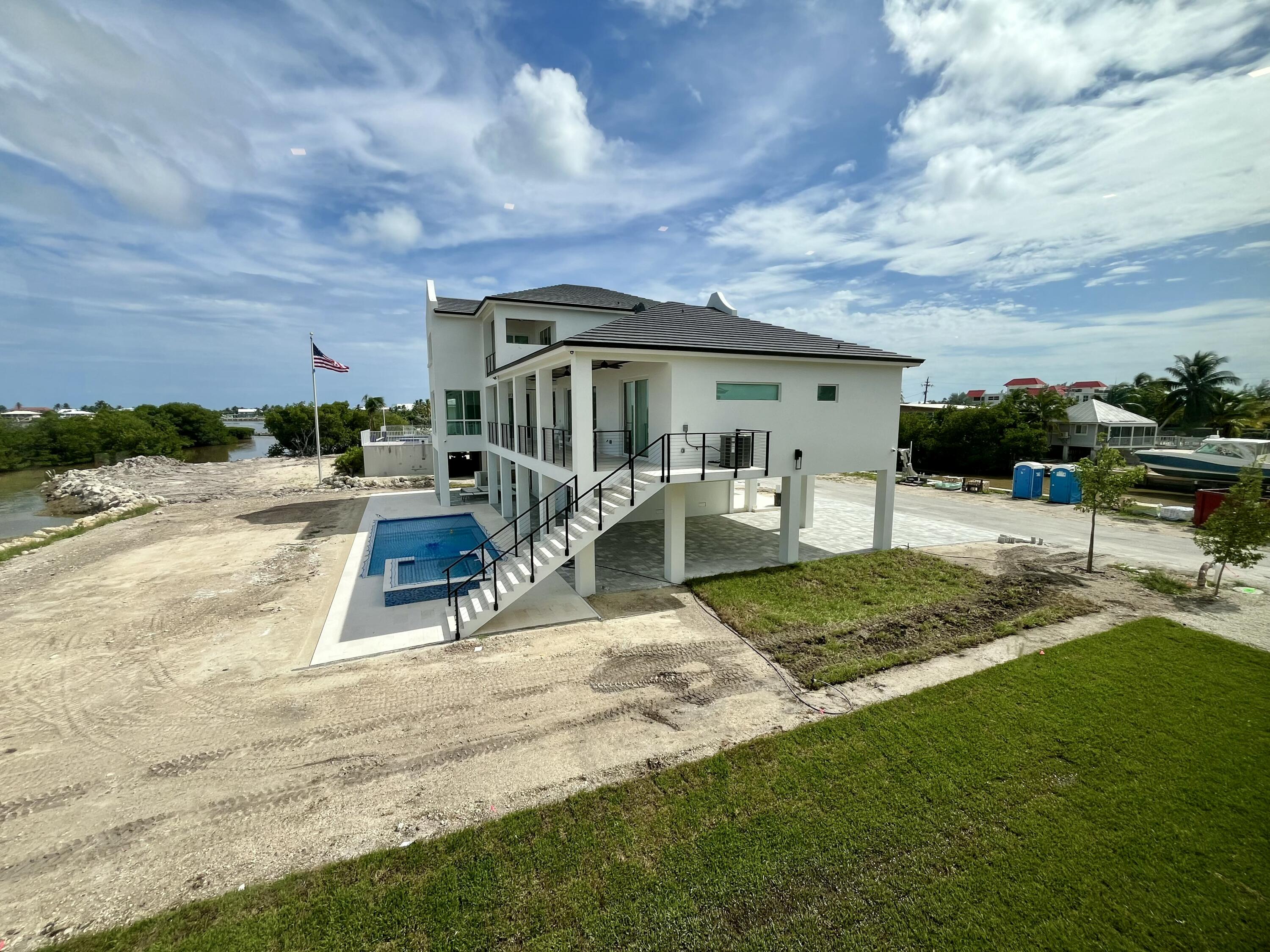 128 Sunrise Drive Marathon, FL 33050 - Photo 30 of 40 a view of a house with backyard and sitting area