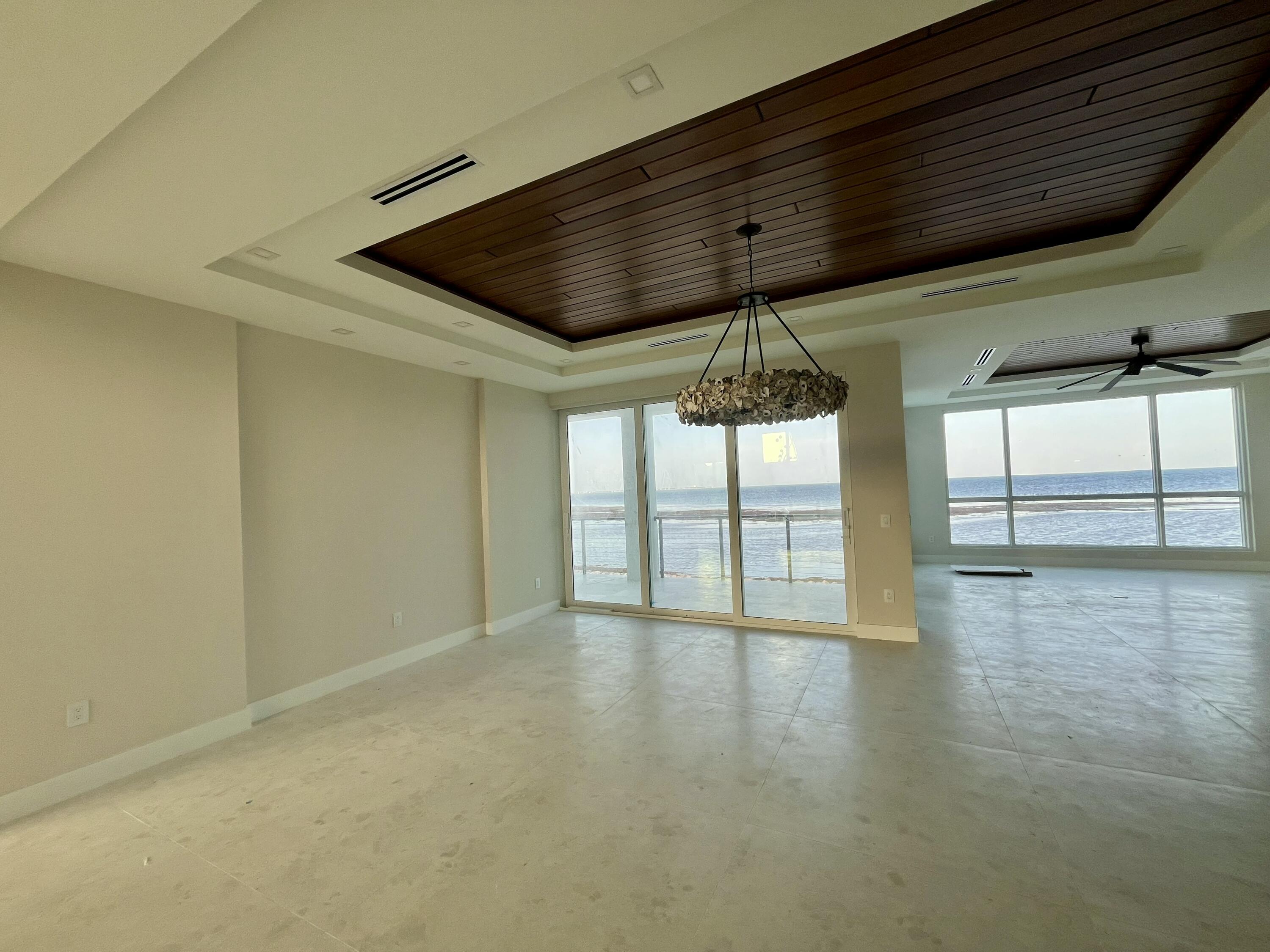 128 Sunrise Drive Marathon, FL 33050 - Photo 7 of 40 an empty room with wooden floor and windows