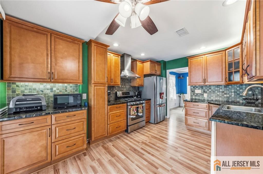 50 3rd Street Fords, NJ 08863 - Photo 16 of 36 a kitchen with stainless steel appliances granite countertop a stove and refrigerator