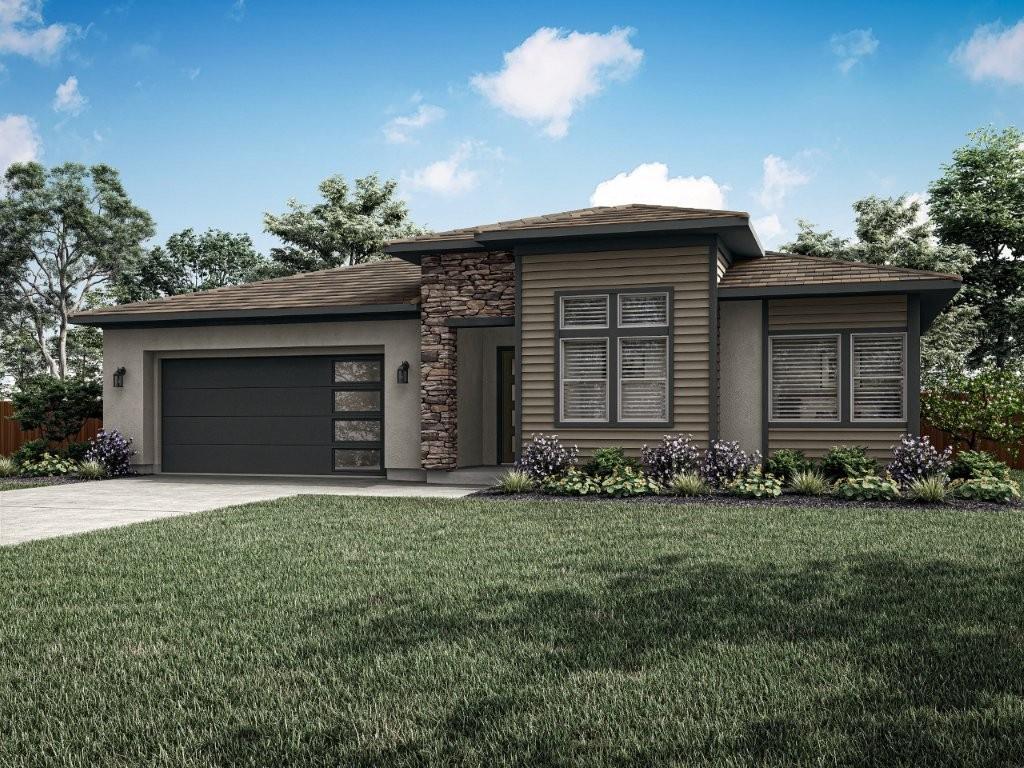 a front view of a house with a garden