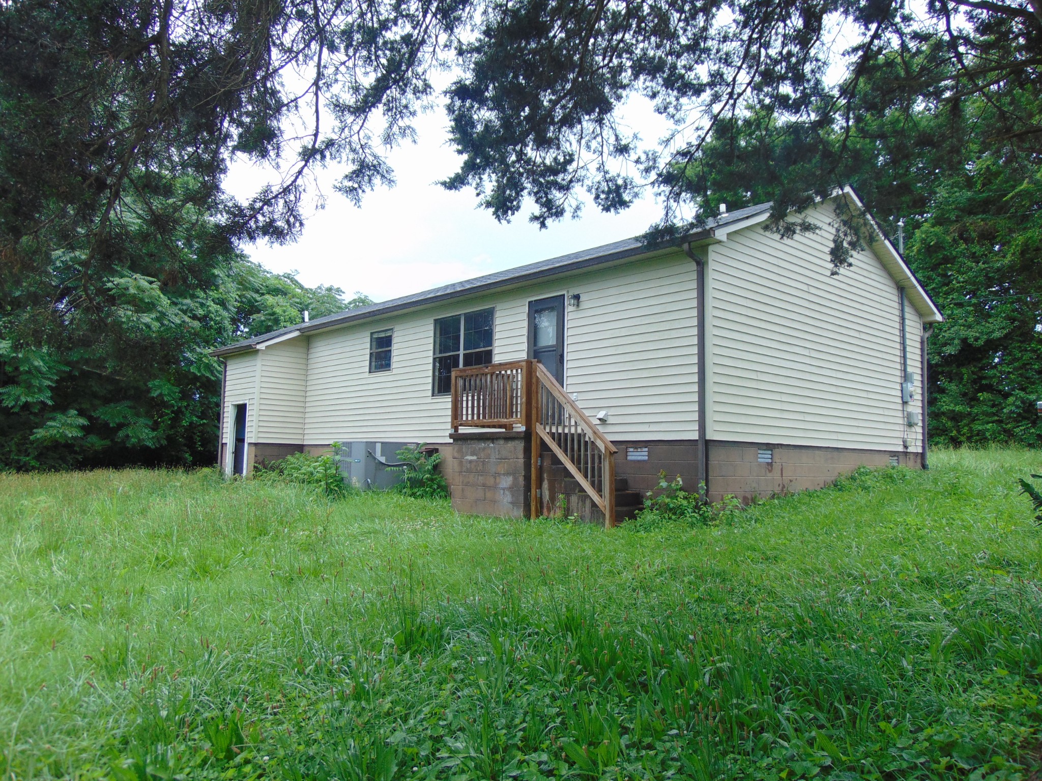 211 Wilson Street Winchester, TN 37398 - Photo 4 of 18 a view of a house with a backyard
