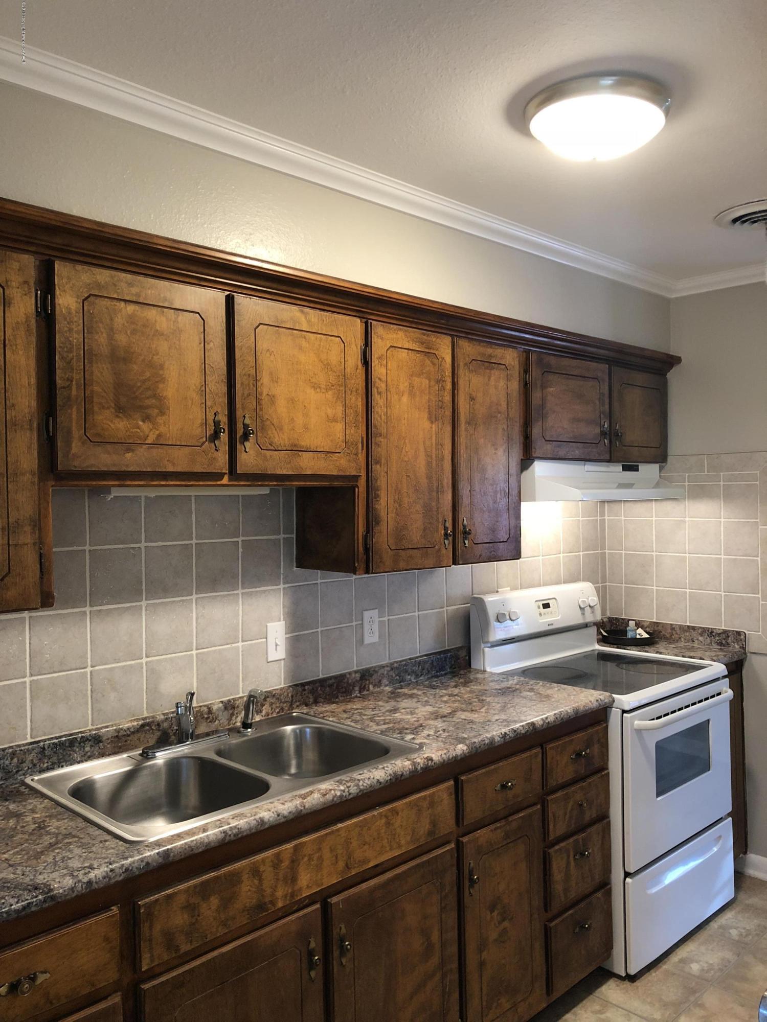 2406 Southwest 49th Avenue Amarillo, TX 79110 - Photo 14 of 38 a kitchen that has a sink and a stove