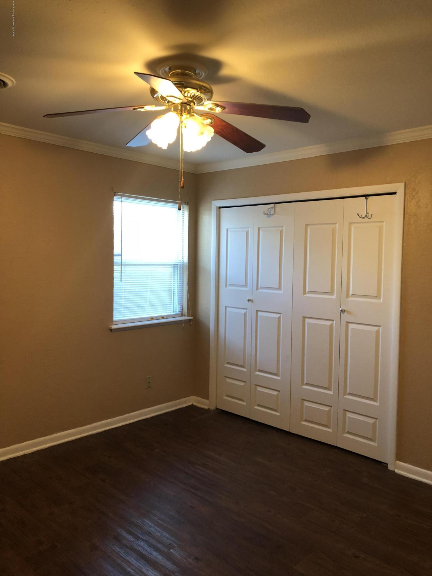 2406 Southwest 49th Avenue Amarillo, TX 79110 - Photo 21 of 38 a view of an empty room with wooden floor and a window