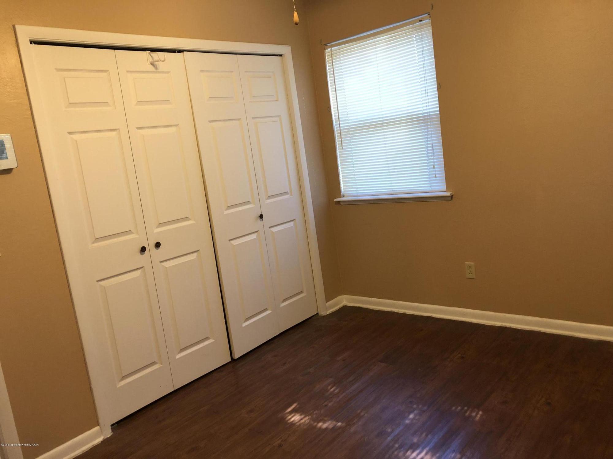 2406 Southwest 49th Avenue Amarillo, TX 79110 - Photo 26 of 38 an empty room with wooden floor and mirror