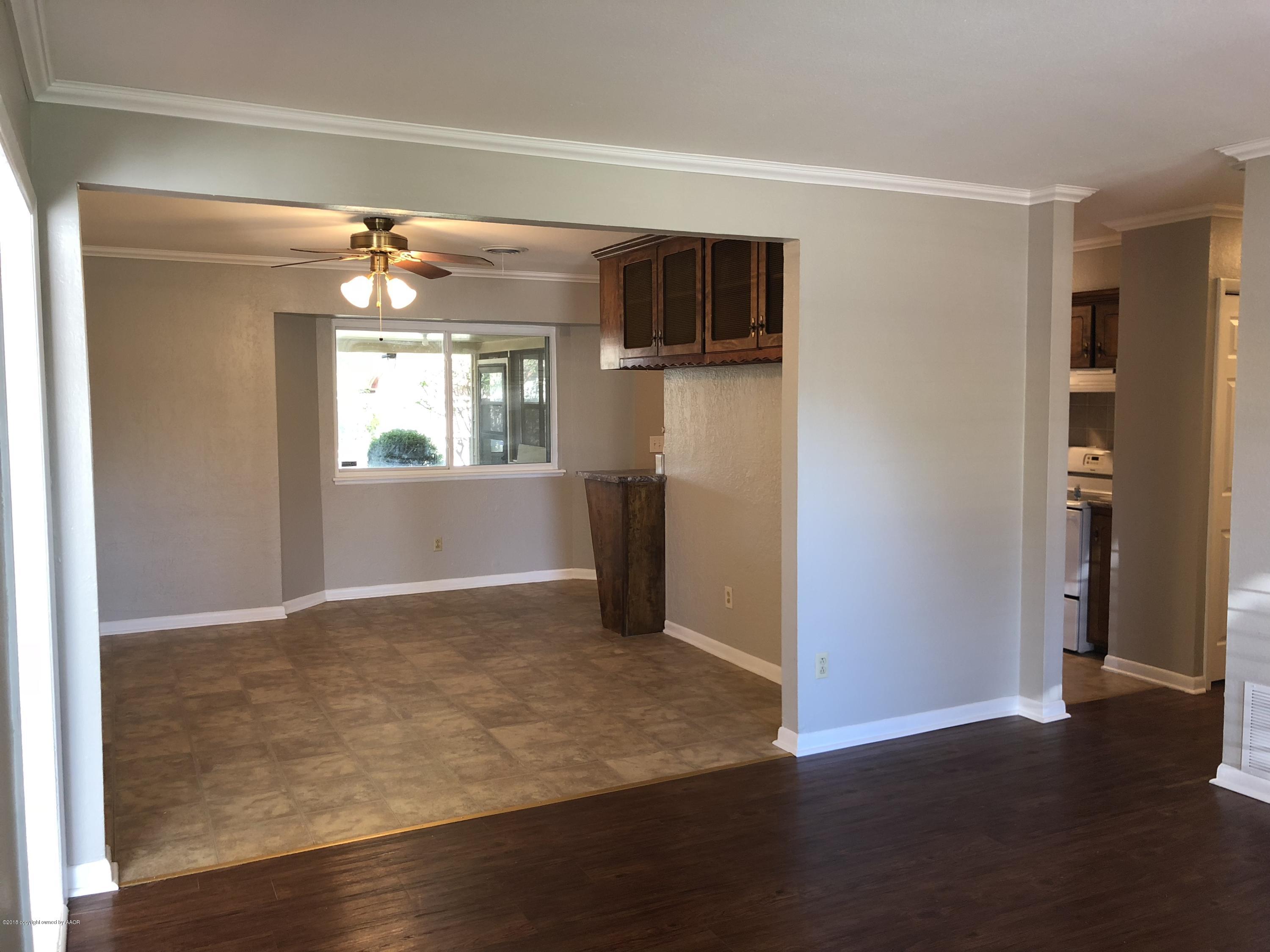 2406 Southwest 49th Avenue Amarillo, TX 79110 - Photo 4 of 38 a view of a livingroom with wooden floor and a window