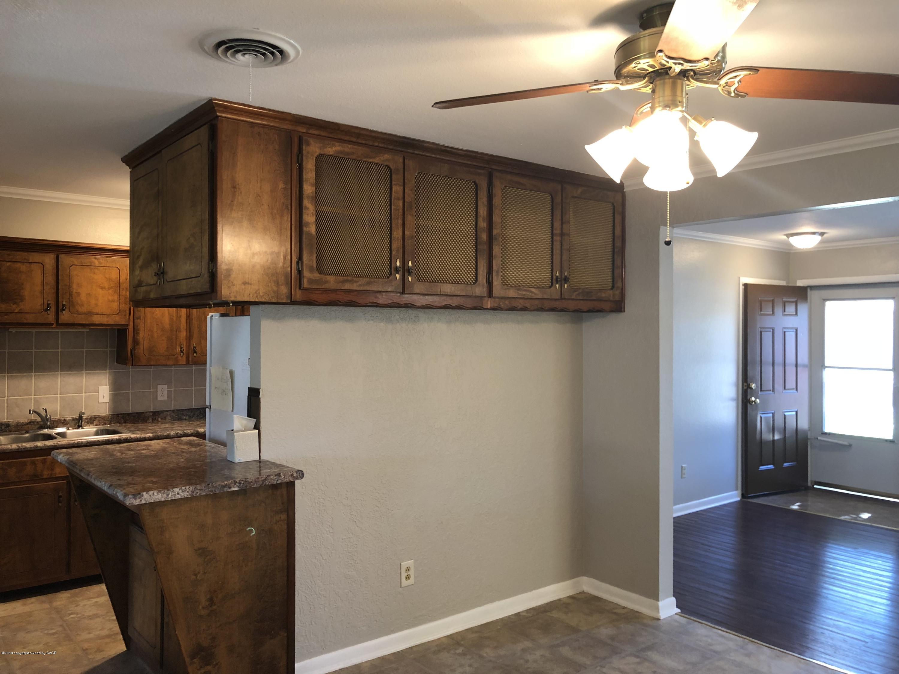 2406 Southwest 49th Avenue Amarillo, TX 79110 - Photo 9 of 38 a kitchen with a refrigerator and a stove