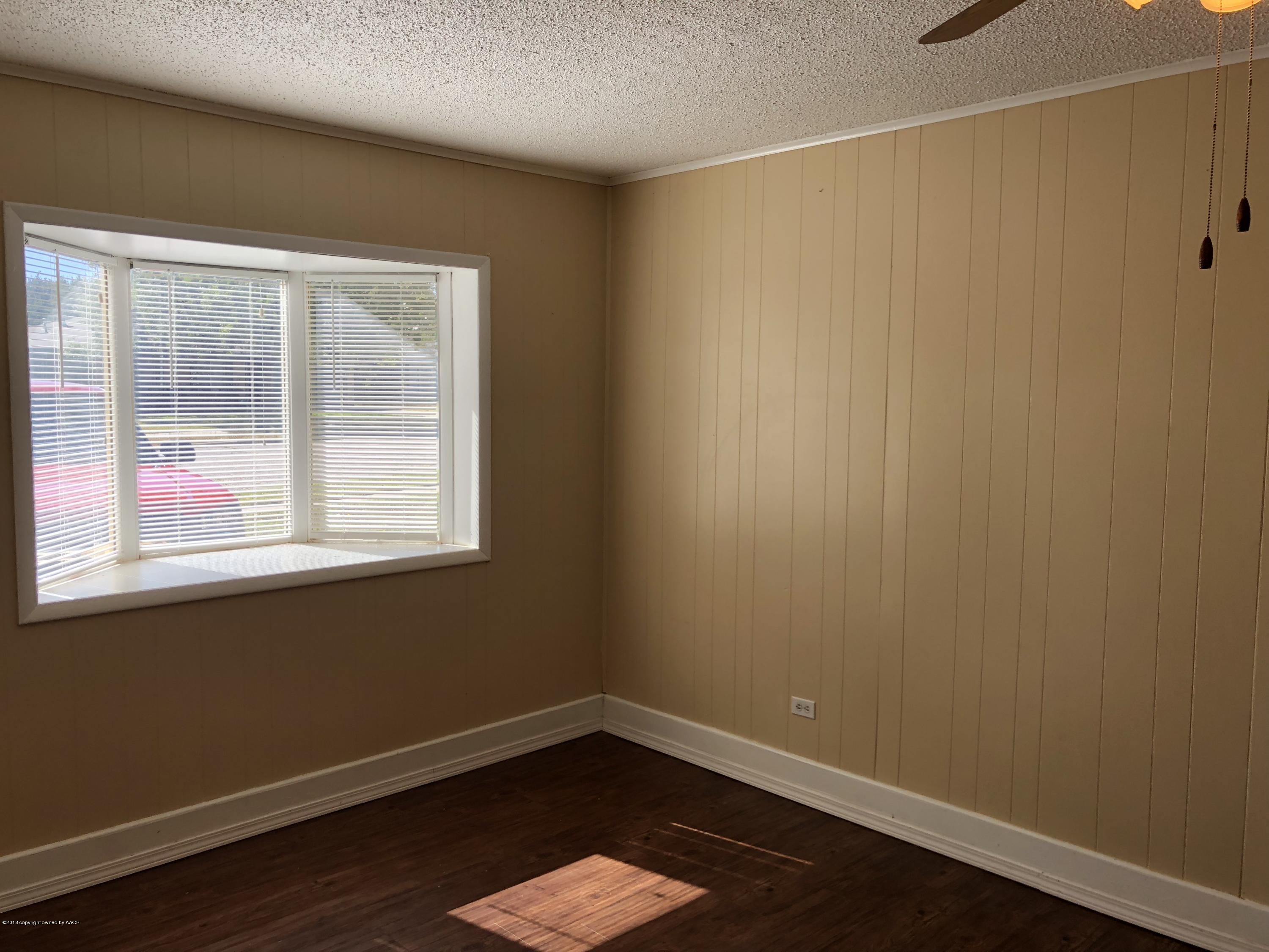 2406 Southwest 49th Avenue Amarillo, TX 79110 - Photo 10 of 38 a view of a small space with wooden floor and a window