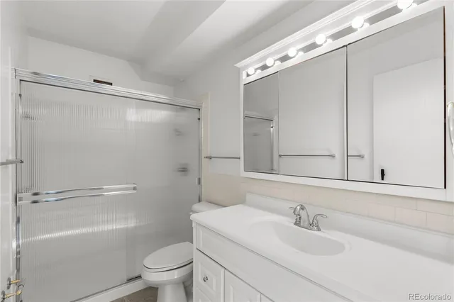 a view of a hallway with wooden shelves and stairs