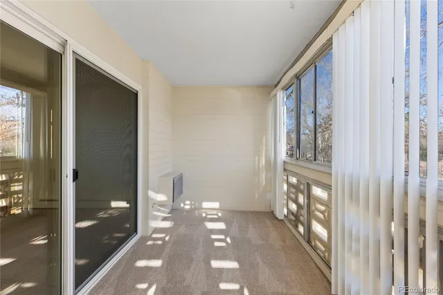 a kitchen with a wooden floor and a refrigerator