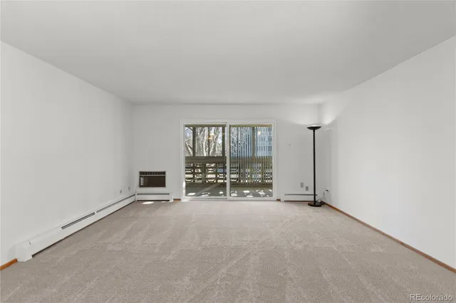 a view of a room with a empty space and windows