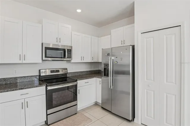 a kitchen with cabinets stainless steel appliances and cabinets