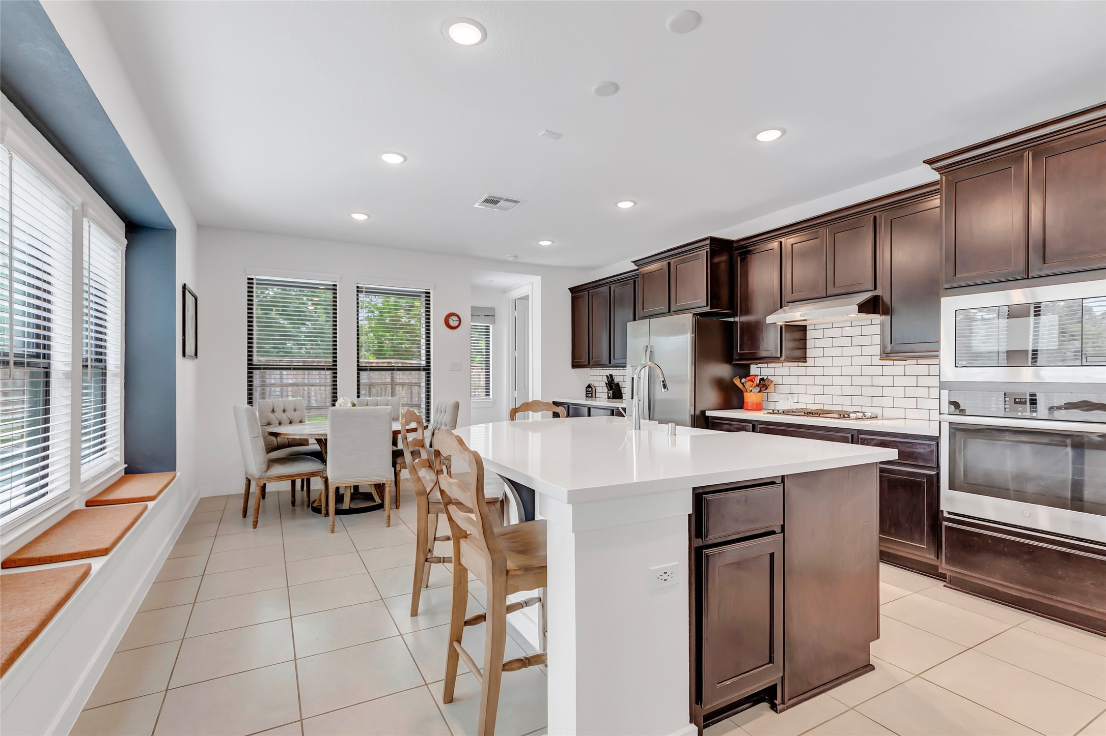527 Chestnut Reef Court Conroe, TX 77304 - Photo 14 of 40 a large white kitchen with a large window and stainless steel appliances