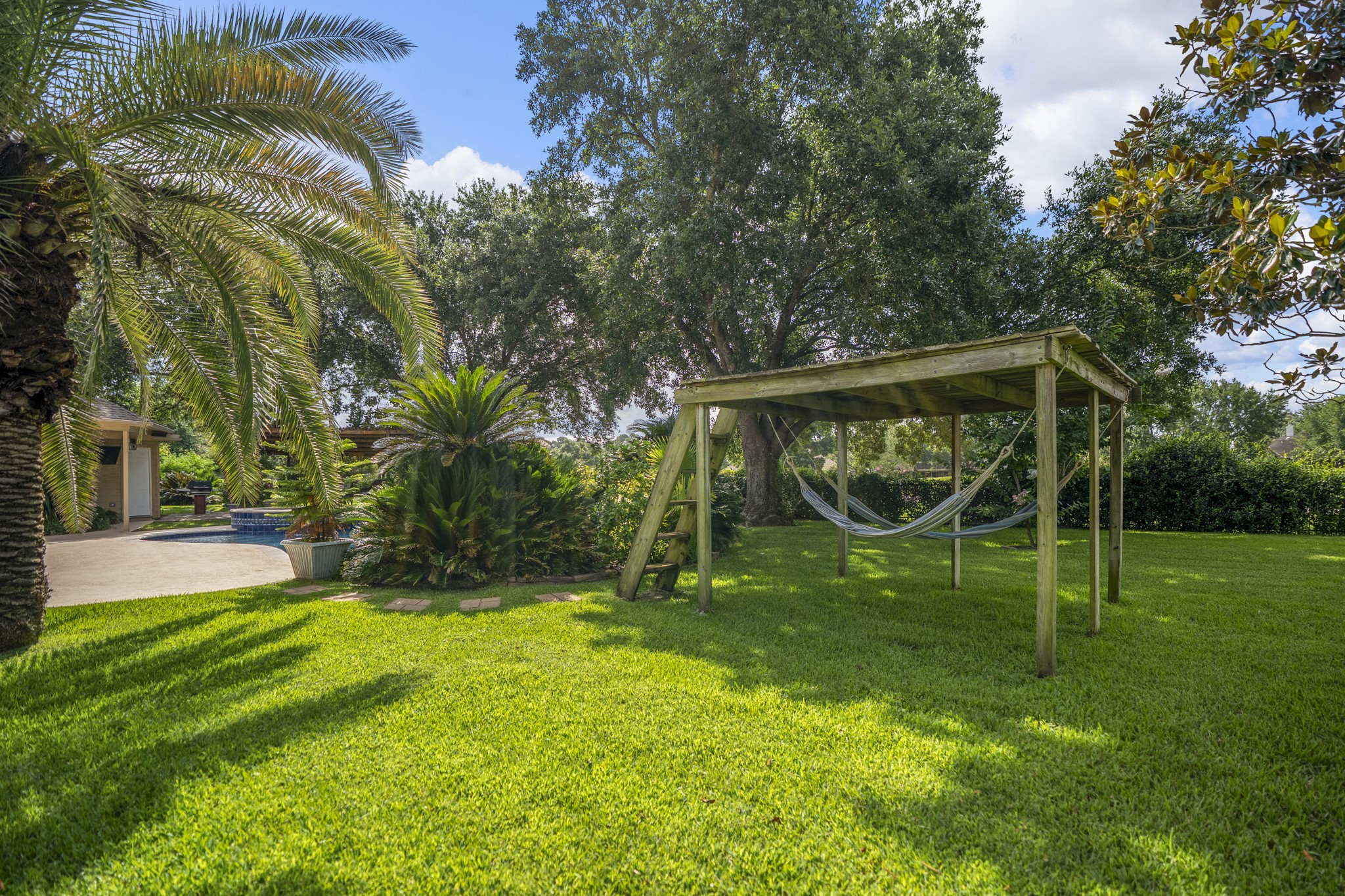 5807 Sequoia Trace Court Spring, TX 77379 - Photo 35 of 50 The hammock area adds another layer to the backyard, offering a shaded spot to slow down between pool time, grilling, and enjoying the golf course setting just beyond the trees.