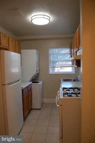 a kitchen with a refrigerator and a stove