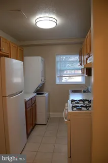 a kitchen with granite countertop a stove a sink dishwasher and a refrigerator