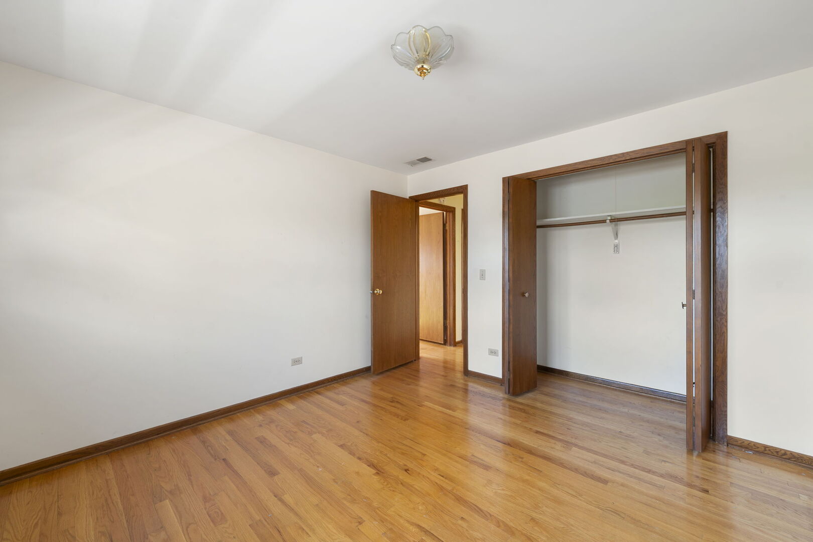 8427 West Windsor Avenue, Unit 2 Chicago, IL 60656 - Photo 23 of 37 a view of an empty room with wooden floor and closet